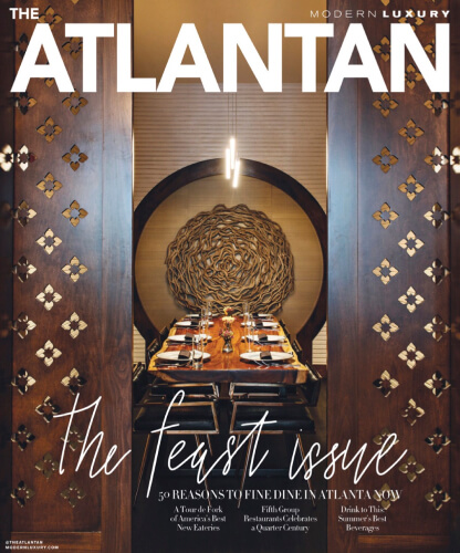 Cover of The Atlantan magazine showing arranged plates on a long table.